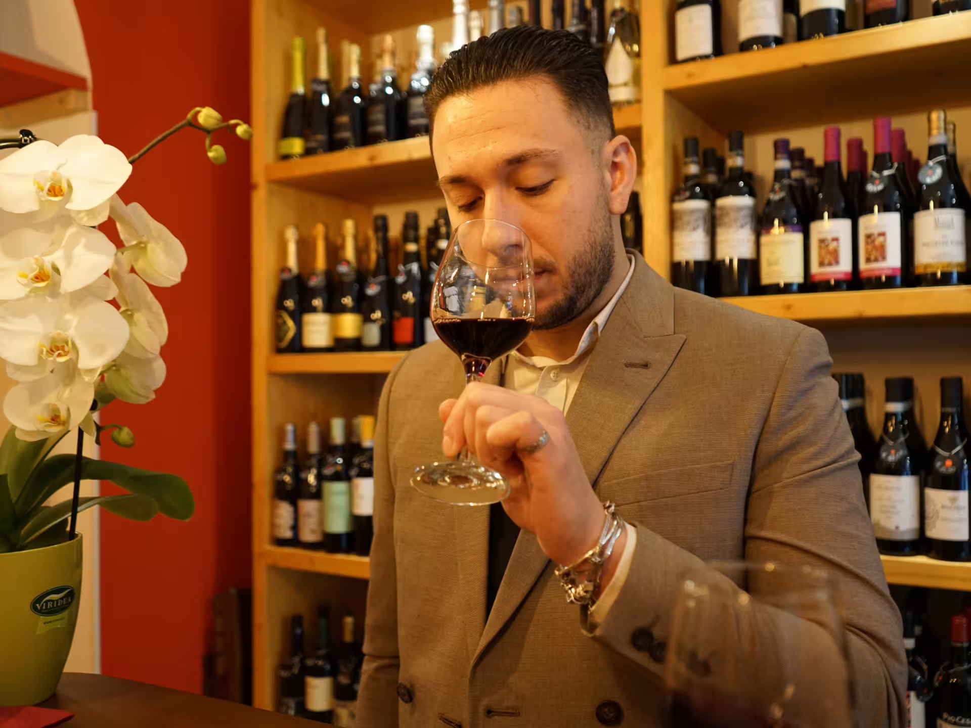 Sommelier-led red wine tasting in Turin city center wine bar, guest swirling glass with local Piedmont labels