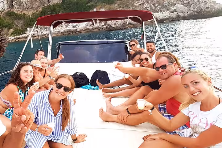 Group enjoying drinks on a boat during the Sorrento Coast Sunset Sail happy hour experience.
