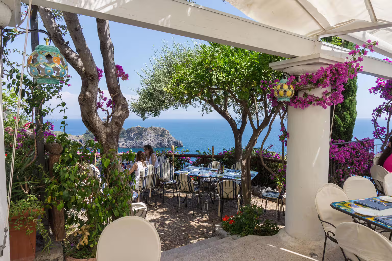 Seaside terrace with bougainvillea and Capri view, lunch stop on Sorrento Positano Amalfi Coast group tour