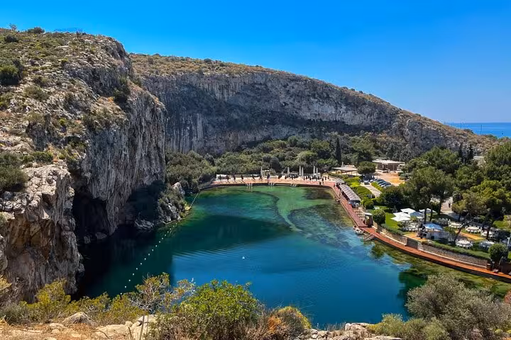 Picturesque lake surrounded by cliffs near Sounio, offering serene views on a Sounio Half Day Private Tour.