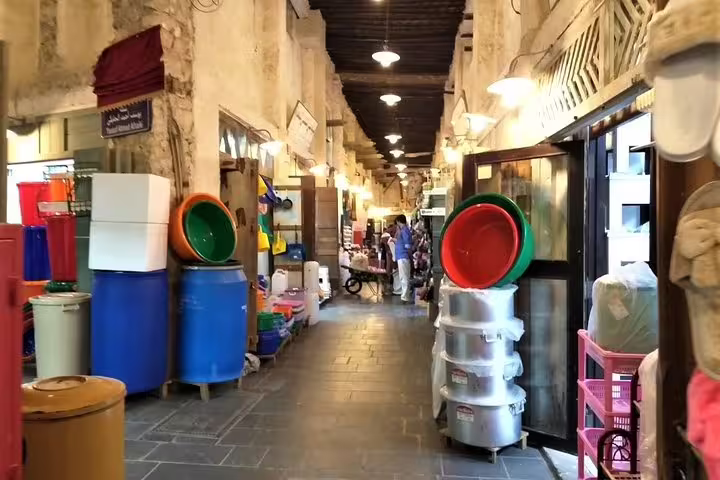Bustling hallway of Souq Waqif with traditional shops and vibrant goods, capturing the essence of Doha's local market.