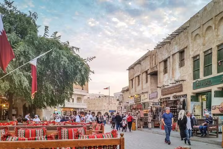 Bustling Souq Waqif in Doha with vibrant market stalls and traditional Qatari architecture, capturing local culture and trade.