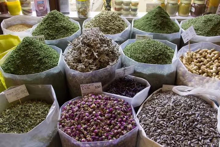 Colorful array of spices and herbs in Souq Waqif, showcasing Doha's rich flavors and aromatic market offerings.