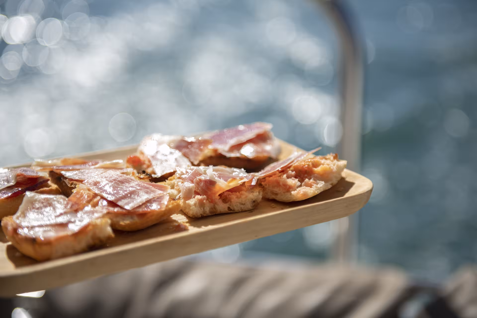 Spanish tapas with jamón served onboard a private luxury catamaran Barcelona tour, Bali 4.2, 4-hour sail