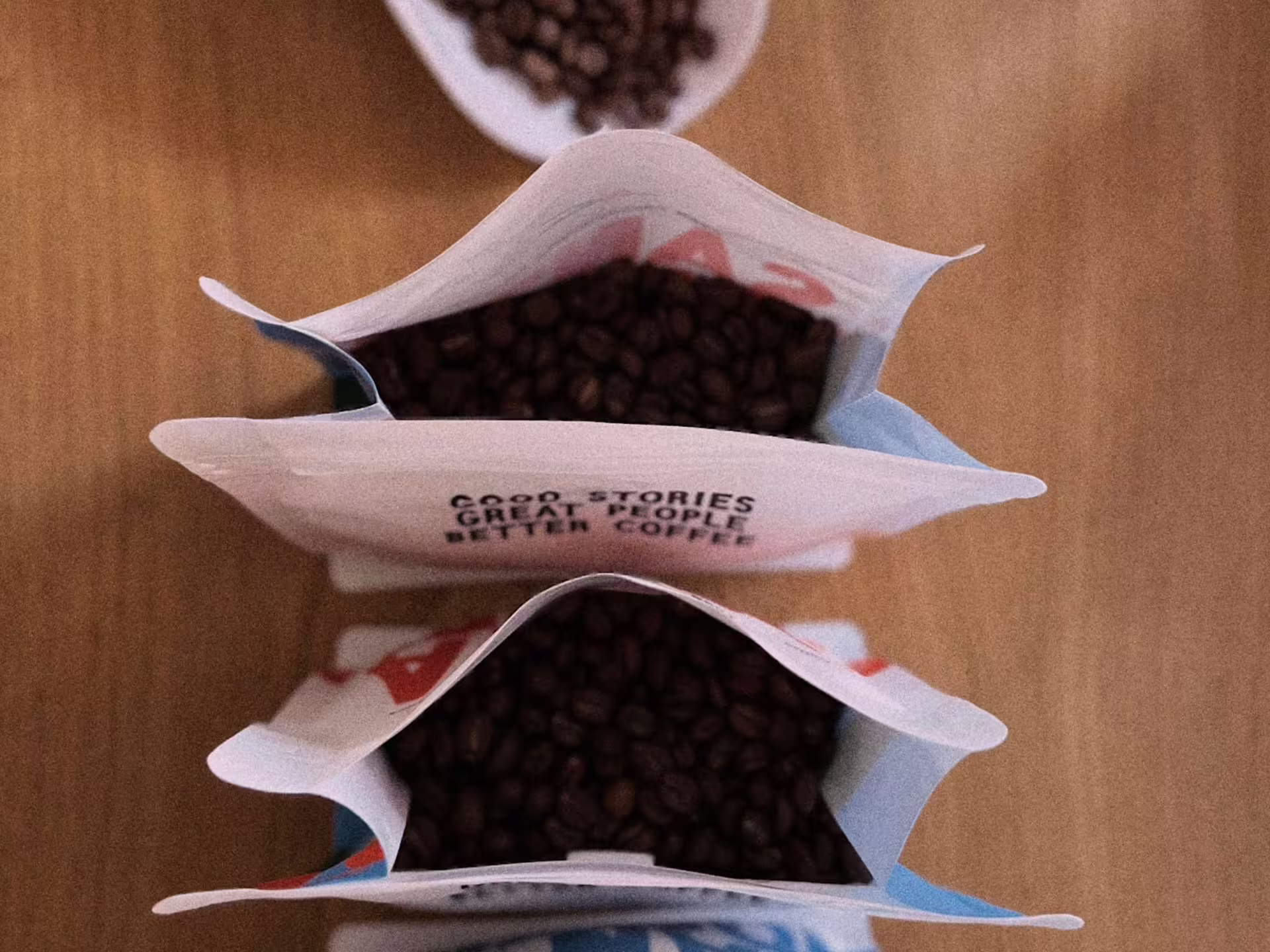 Opened bags of freshly roasted coffee beans ready for tasting at a Turin roastery experience.