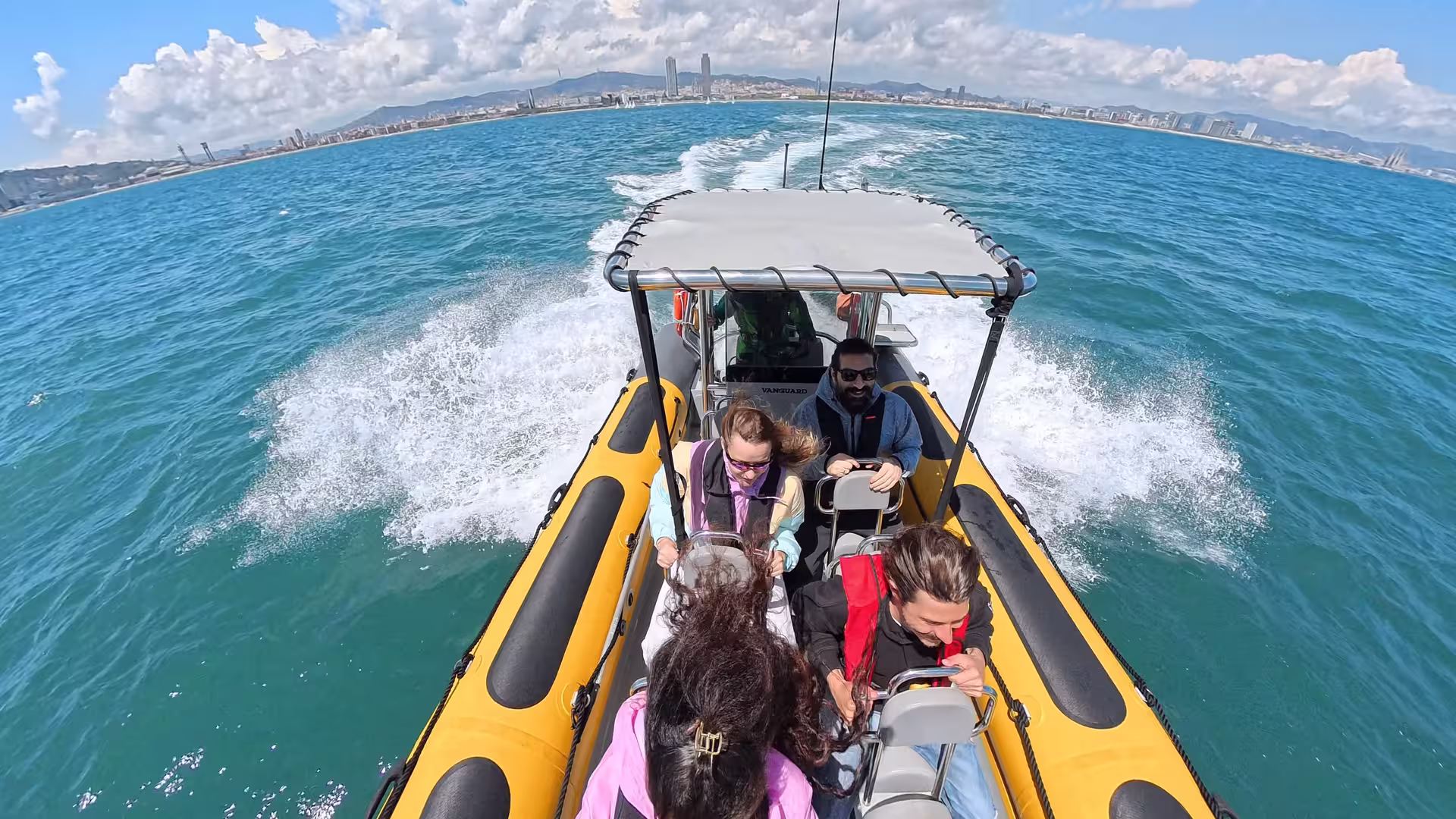 Thrilling speed boat ride on the Mediterranean Sea with stunning Barcelona skyline, perfect for adventure seekers.