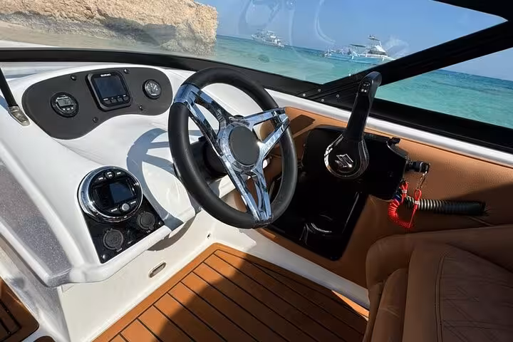 Private speedboat cockpit and steering wheel on Red Sea, Hurghada to Magawish Island snorkeling trip