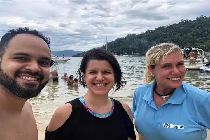 Tourists enjoying a day at the beach in Angra dos Reis during a full-day speedboat tour from Rio de Janeiro.