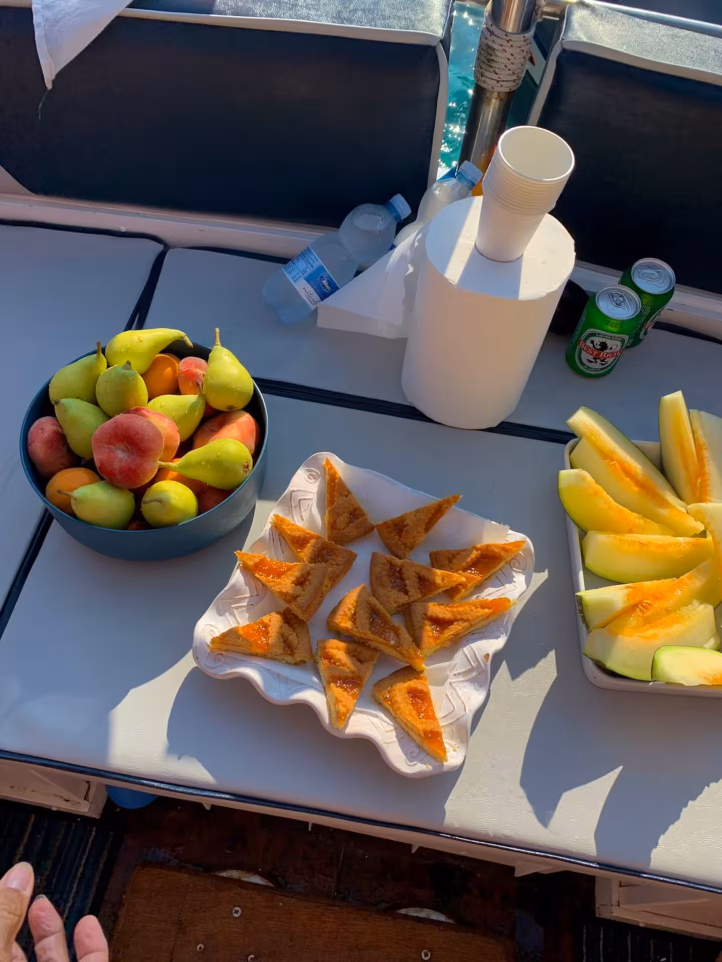 A delicious spread of fresh fruit and pastries on a speedboat in the La Maddalena Archipelago tour from Palau.