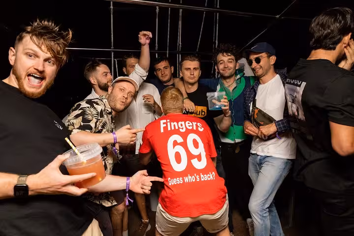Group of friends celebrating on the Split After Dark boat crawl, showcasing fun and camaraderie with drinks in hand.
