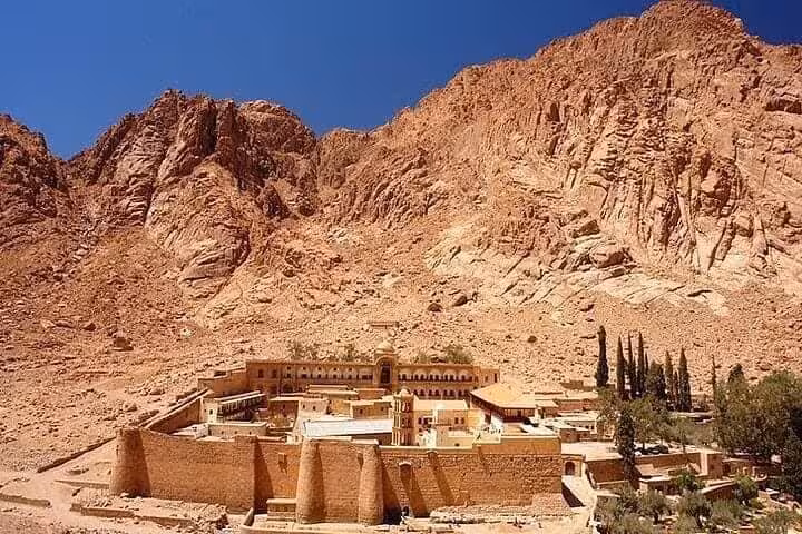 St Catherine Monastery beneath towering Sinai cliffs, view from Saint Catherine Mountain hike Egypt