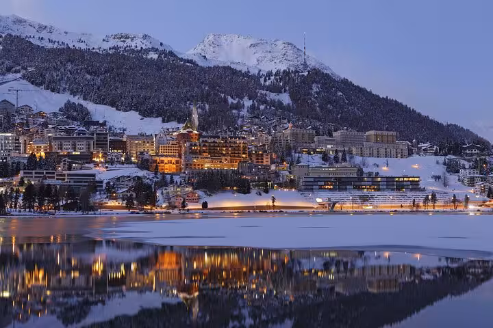 St. Moritz at dusk with snowy Alps and lake reflections, scenic stop on Bernina Express tour