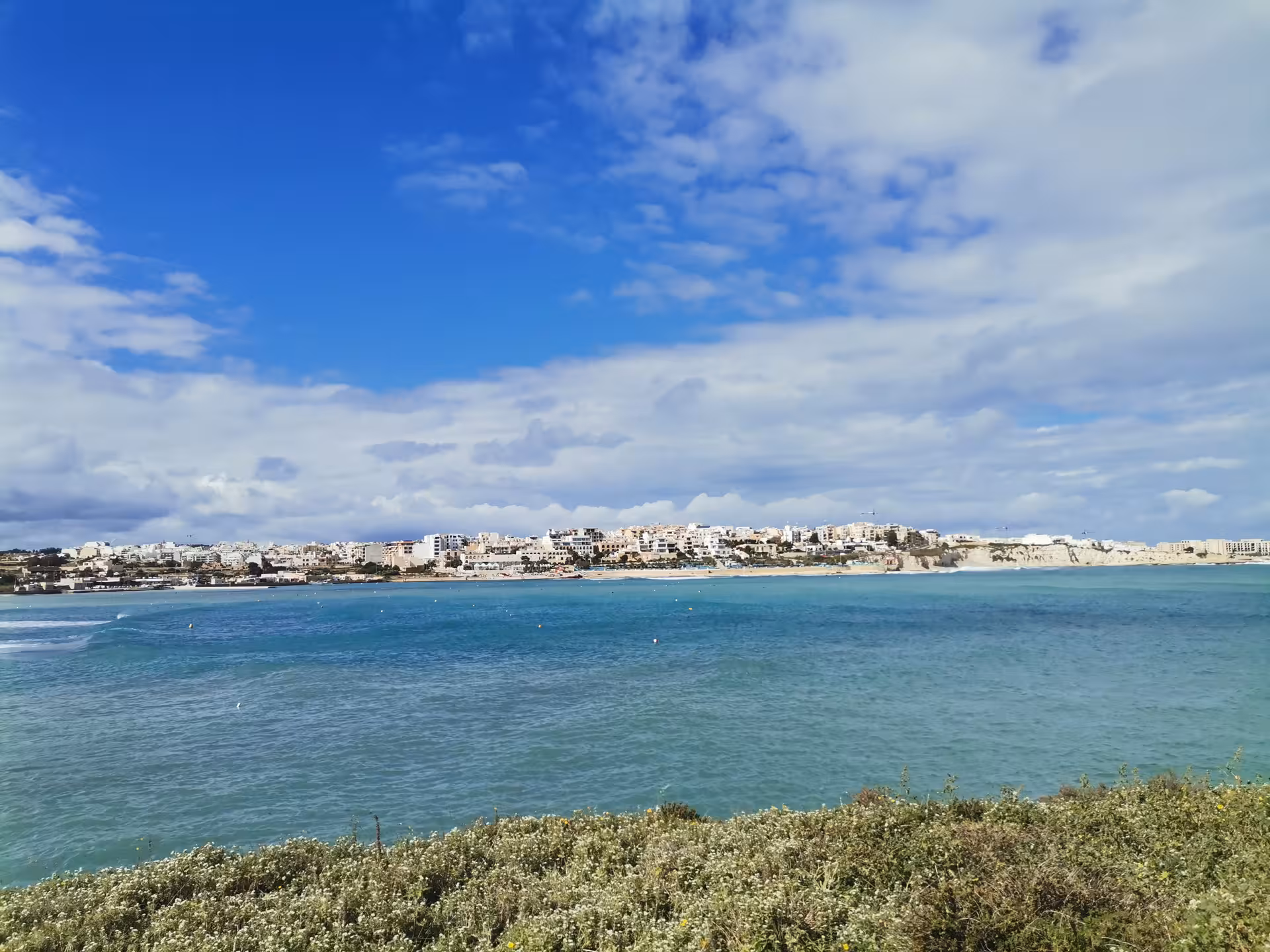 Panoramic view of St Paul’s Bay coastline and turquoise sea in Malta on a scenic hiking tour with picnic