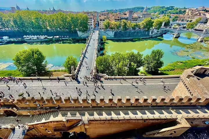 Panoramic view from Castel Sant’Angelo over the Tiber River and Ponte Sant’Angelo, included in St Peter’s Basilica dome combo tour
