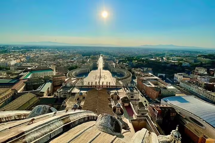 Panoramic sunrise view from St Peter’s Basilica dome overlooking St Peter’s Square and Rome on Vatican combo tour