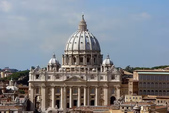 St. Peter's Basilica exterior under a clear sky, showcasing its iconic dome on the Vatican Tour in Rome.