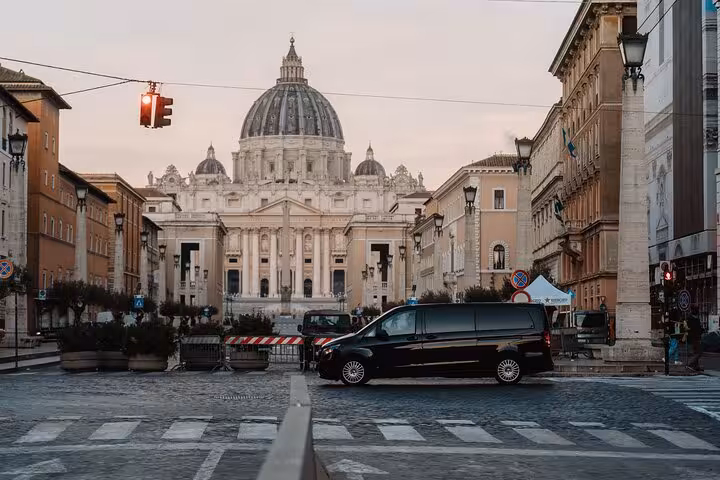 St. Peter's Basilica at sunset framed by city streets, featured on the Rome Highlights Tour with cooking experiences.