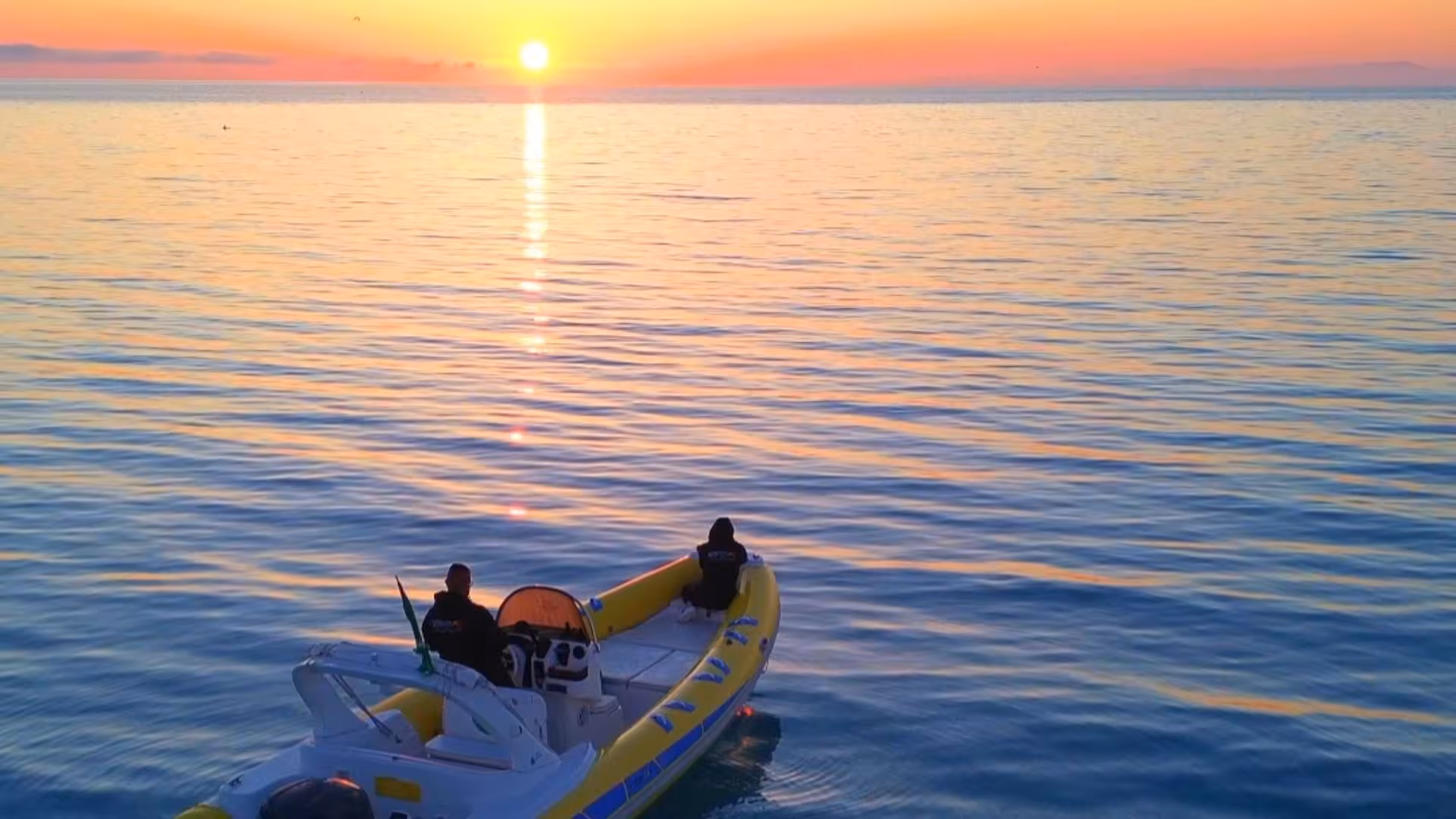 Scenic sunrise view from a dinghy tour near Stintino, capturing vibrant skies and tranquil waters.