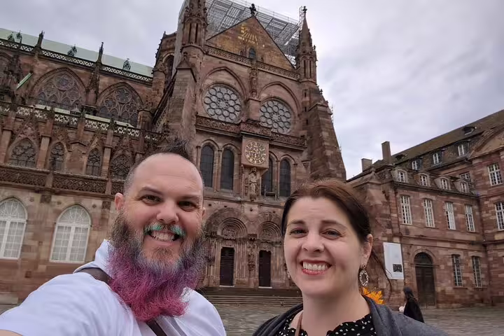 Couple selfie in front of Strasbourg Cathedral on a scavenger hunt walking tour exploring top city highlights
