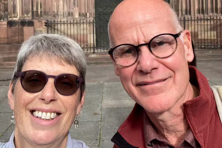 Couple selfie outside Strasbourg Cathedral during scavenger hunt city highlights walking tour in France