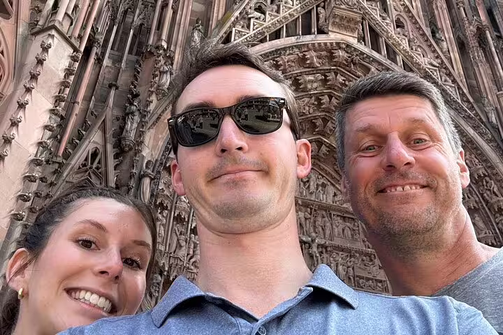 Group selfie by Strasbourg Cathedral portals during a Strasbourg scavenger hunt and city highlights walking tour