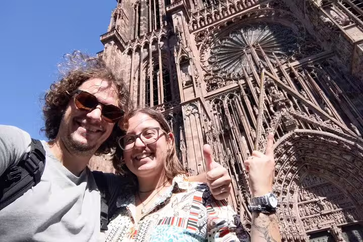 Happy travelers selfie at Strasbourg Cathedral, a fun scavenger hunt and city highlights walking tour stop