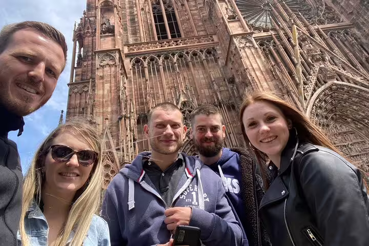 Group photo by Strasbourg Cathedral façade on a self-guided scavenger hunt and city highlights walking tour