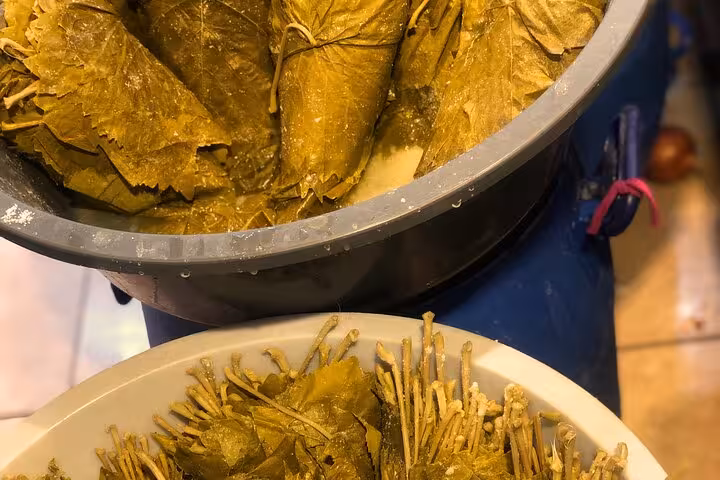 Close-up of stuffed vine leaves and fresh grape leaves prepared for traditional Turkish cooking in İstanbul