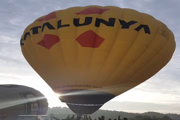 Sunrise illuminates a hot air balloon in Igualada, promising a stunning aerial tour of the Catalonia landscape.