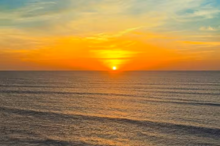 Sunset over Jericoacoara beach and Atlantic Ocean, glowing horizon view on the Jeri sunset ATV tour route