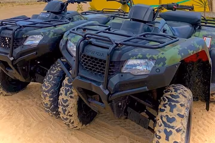 Camouflage ATVs on sandy track in Jericoacoara, ready for sunset dune ride and off-road adventure tour