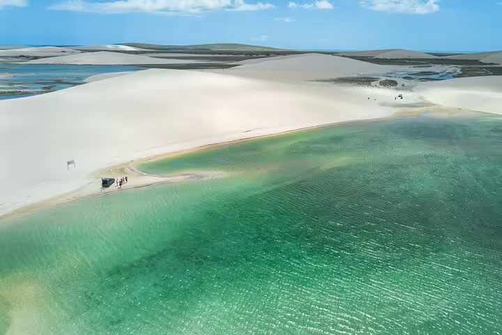 Aerial view of turquoise lagoon and white dunes near Jericoacoara, scenic stop on sunset ATV tour route