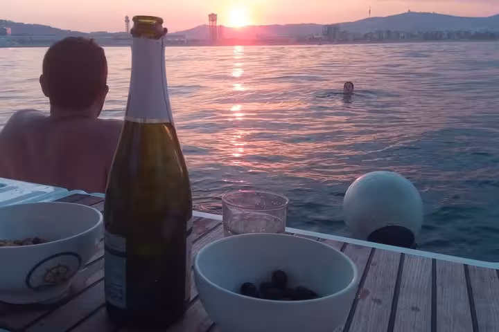Sunset sailing in Barcelona with cava open bar and snacks on deck, swimmers in the Mediterranean