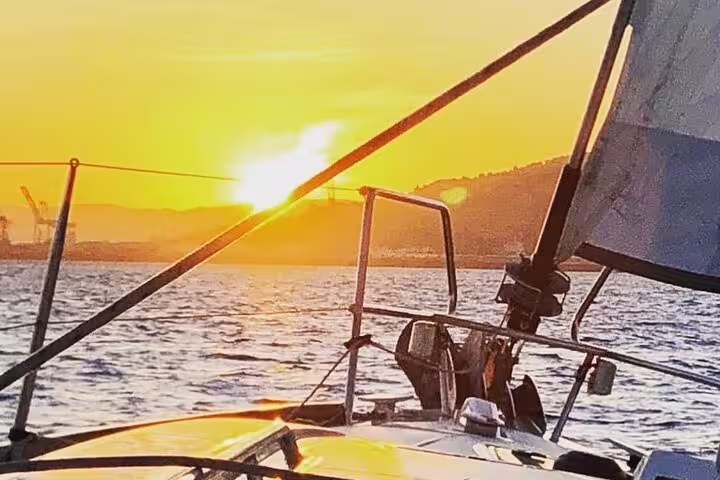 Sail into a stunning sunset on our 2-hour sailing experience with open bar and tapas, capturing the beauty of the ocean horizon.