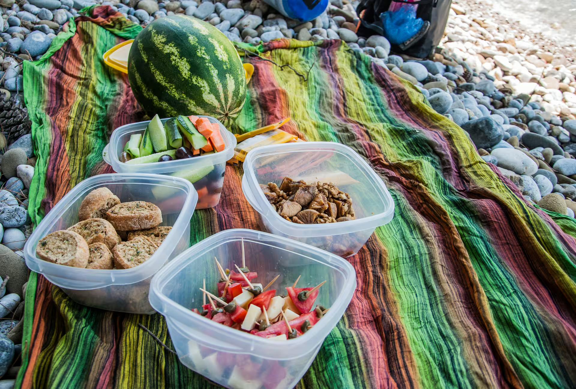 Beach picnic snacks after SUP in Kardamyli, Mani—fresh fruit, bites and watermelon on a pebble shore