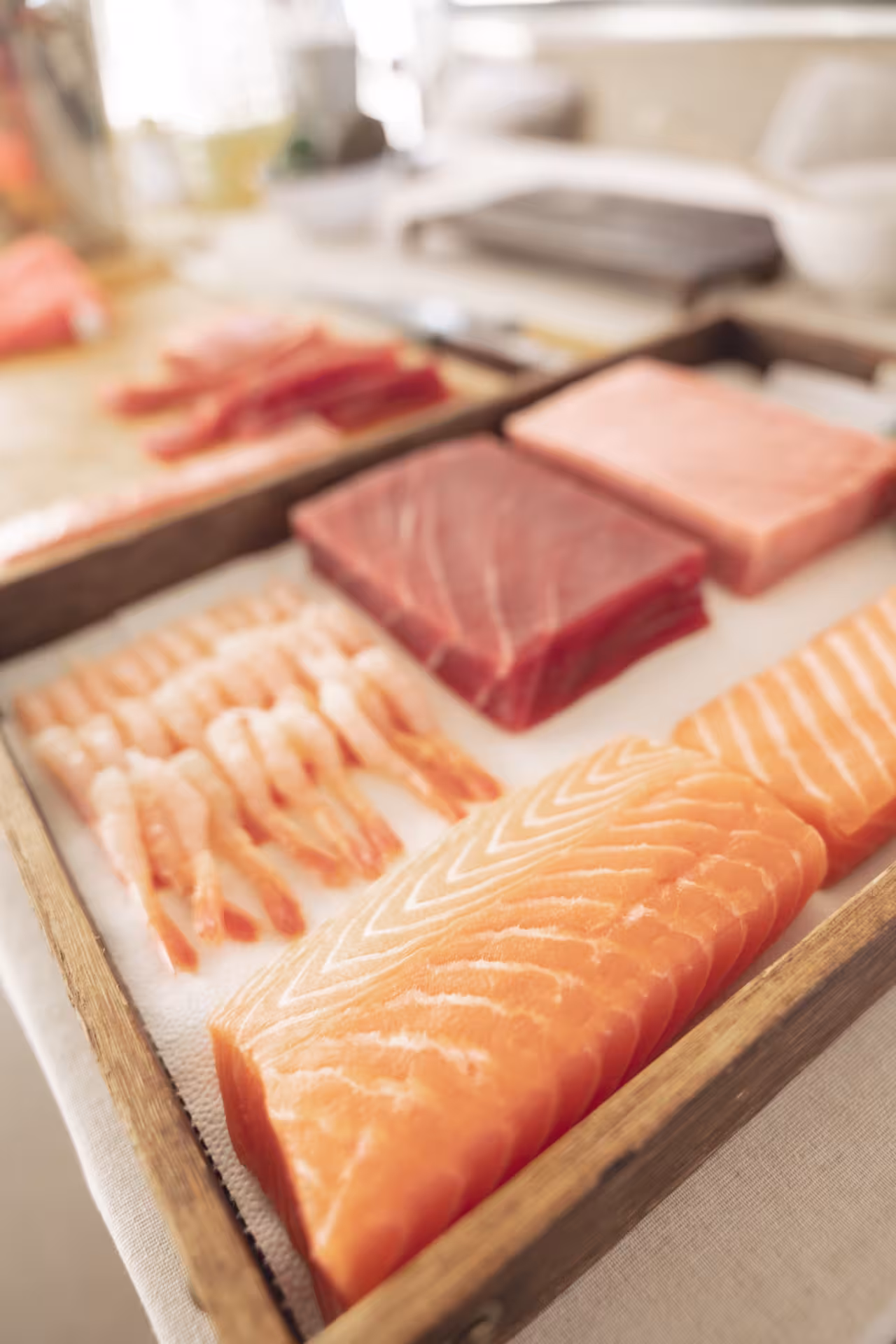 Fresh sushi-grade salmon, tuna and shrimp laid out for a hands-on Sushi Masterclass prep session