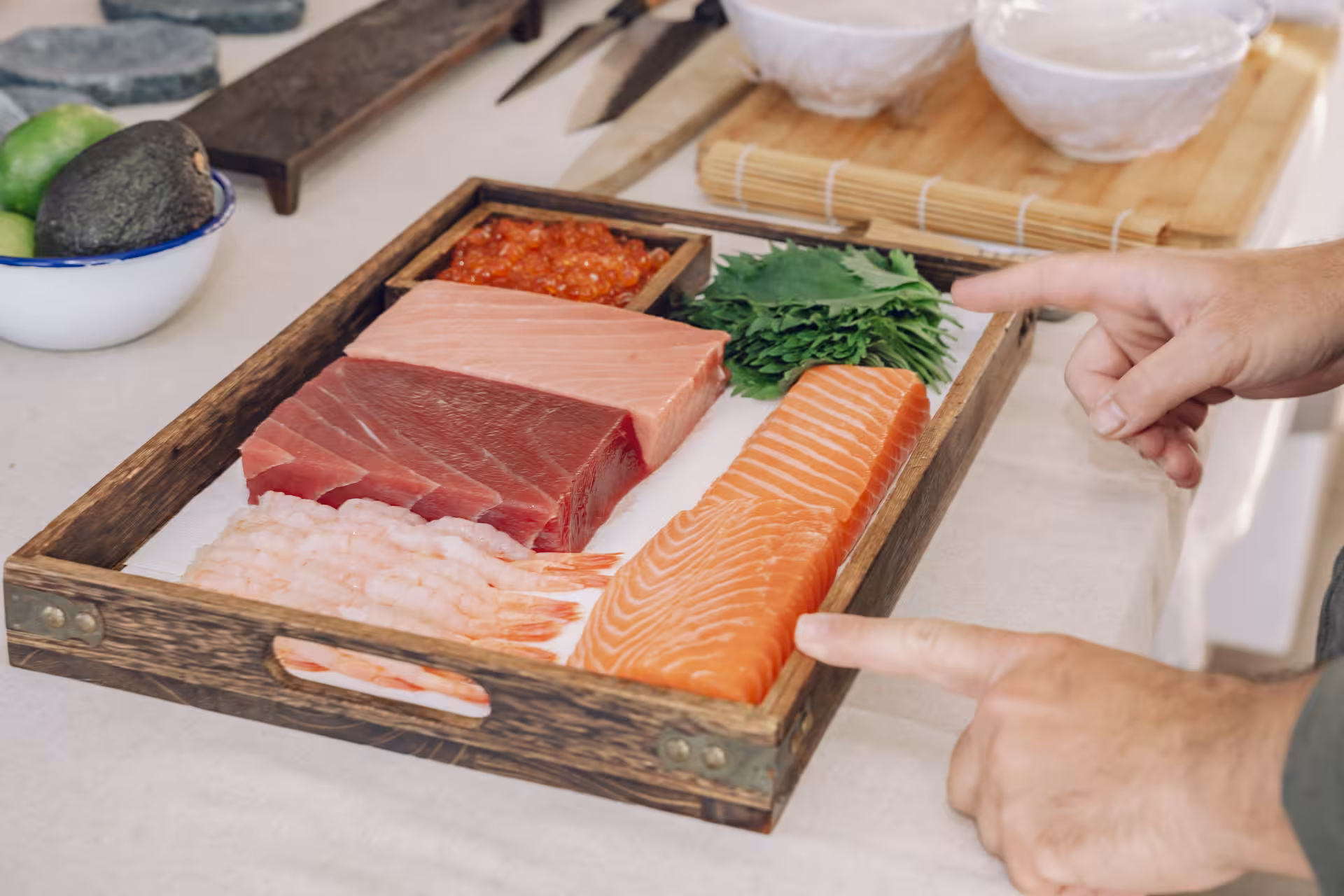Fresh sashimi ingredients on tray—salmon, tuna and shrimp—prepared for hands-on Sushi Masterclass lesson