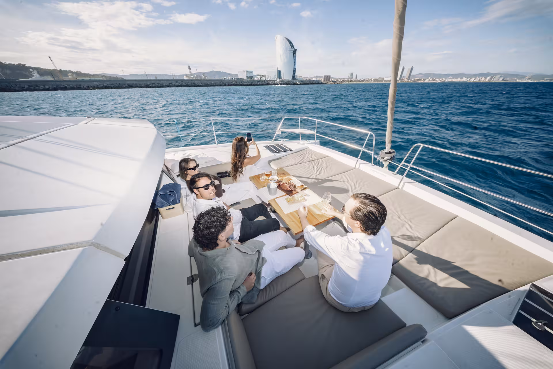Friends enjoying sushi spread on a yacht, perfect for Sushi Masterclass experience with fresh seafood and views