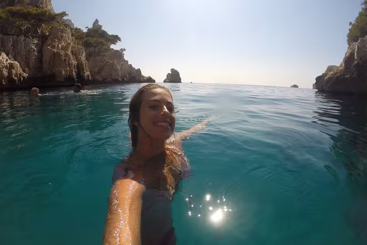 Swimmer in turquoise Calanques cove near Marseille, refreshing dip after guided hike in Calanques National Park