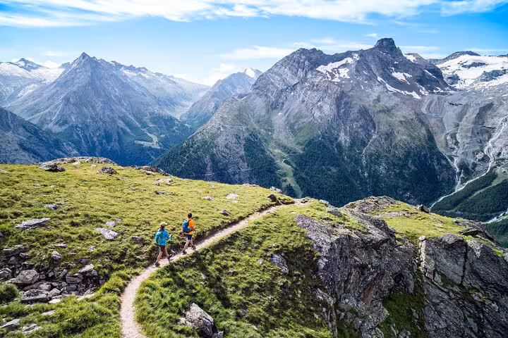 Hikers on a high alpine trail with Jungfrau-region peaks, Swiss Alps from Zurich Airport tour adventure