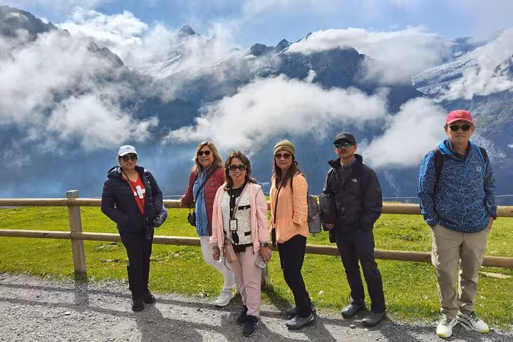 Tour group at Swiss Alps lookout with glacier views, Jungfrau Region hidden gems on 4-day Zermatt trip