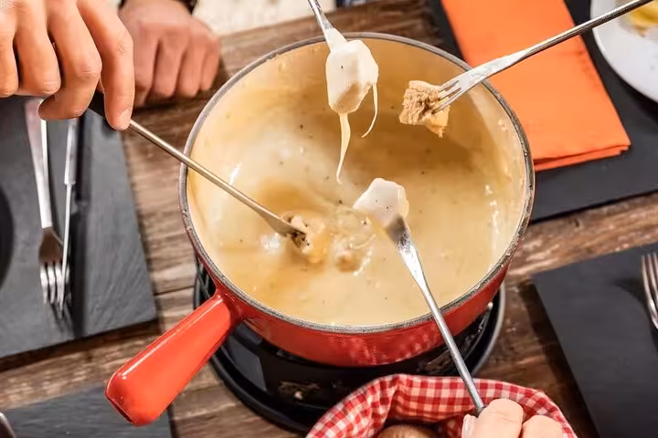 Delicious Swiss fondue experience with Swiss Travel Pass Tours, offering customizable itineraries and private guides.