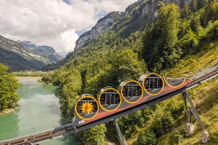 Explore Swiss landscapes aboard a scenic funicular ride through lush valleys with the Swiss Travel Pass Tours.