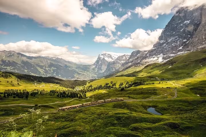 Scenic Swiss train journey through lush valleys and majestic mountains with the Swiss Travel Pass Tours.