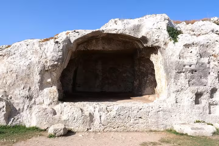 Discover the intriguing ancient cave tomb in Syracuse's rocky landscape, a must-see on the Syracuse and Noto itinerary.