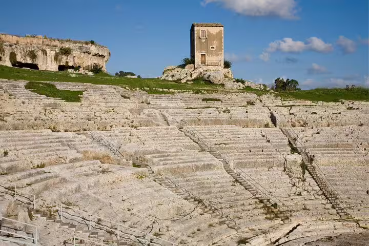 Ancient Greek Theater of Syracuse stone seating, highlight on Ortigia scavenger hunt and self-guided tour