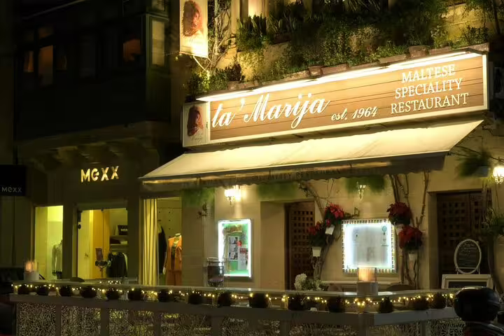 Exterior view of Ta' Marija restaurant, a key venue for the Maltese Folklore Night Tour, beautifully lit at night.