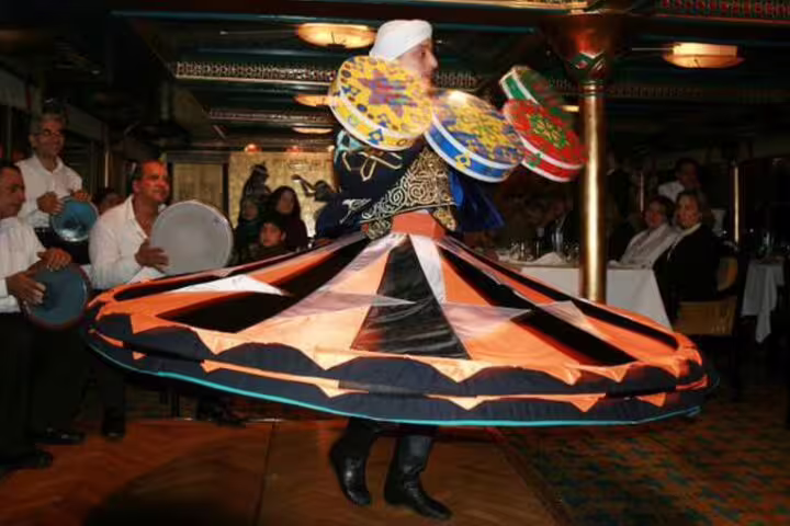 Tanoura whirling dervish show with colorful skirts on Luxury Cairo Nile dinner cruise aboard Nile Maxim