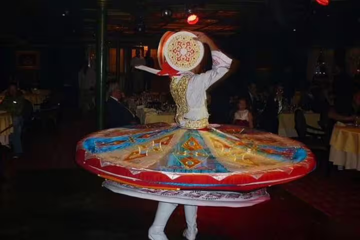Tanoura whirling dervish performer on Nile Maxim Cairo dinner cruise, traditional Egyptian show with dining