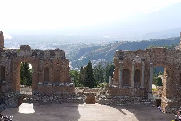 Ruins of Taormina's Greek Theatre showcasing ancient architecture with panoramic vistas, a must-see for tourists.